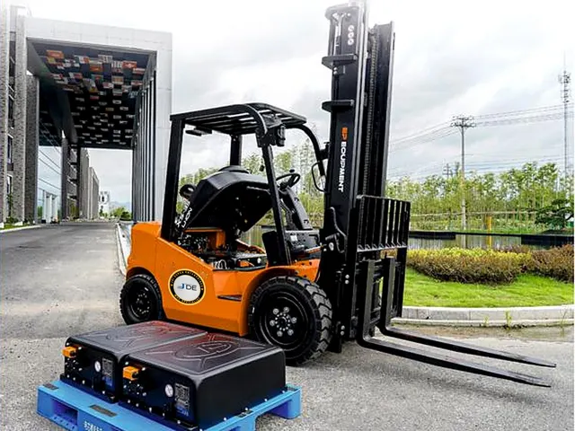 Orange electric forklift with lithium battery pack - Jai Durga Enterprises